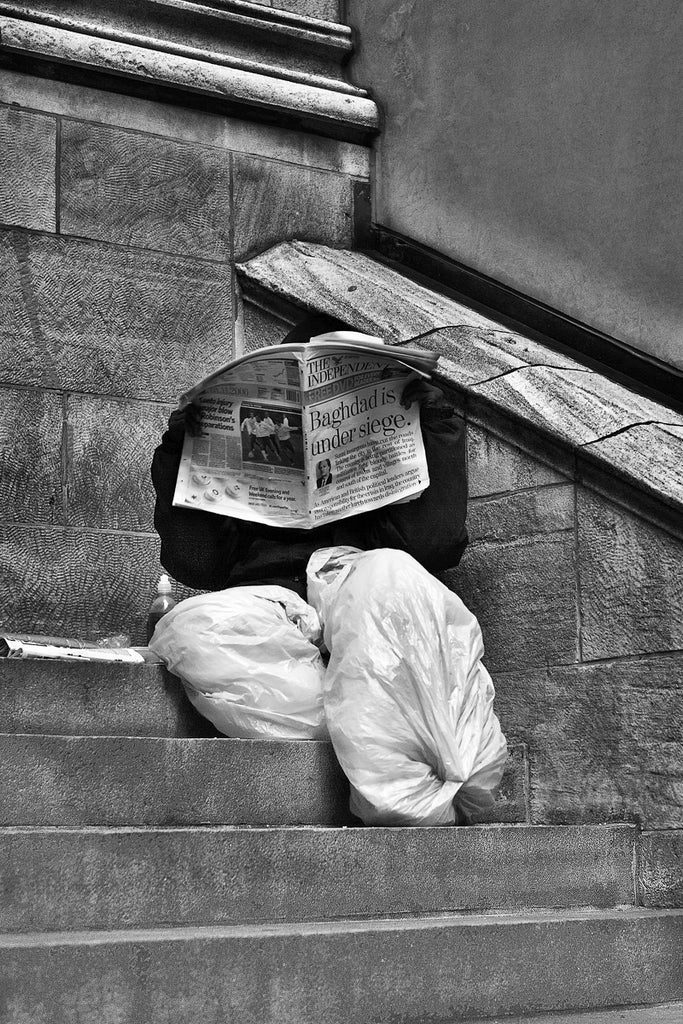 ic: Homeless man in New York City is reading a current events newspaper is authentic but in the world of fake AI imagery, how would you know?