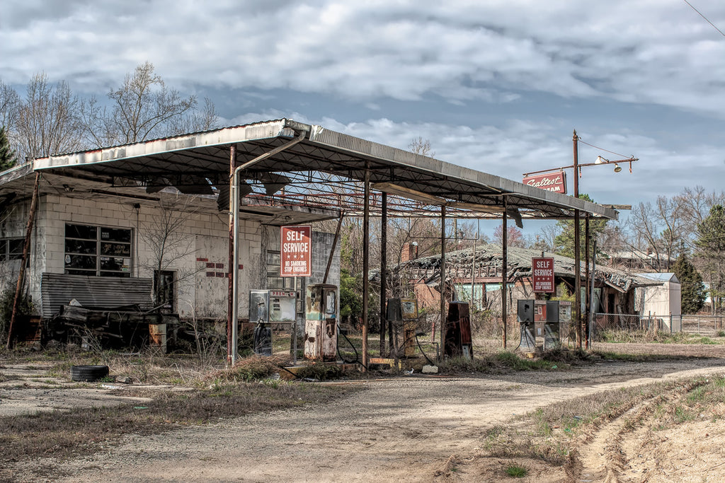 ic:A relic of the past, this long-abandoned gas station in Georgia stands as a poignant reminder of bygone days, its rusted pumps and weathered structures whispering tales of erstwhile travelers and forgotten journeys.