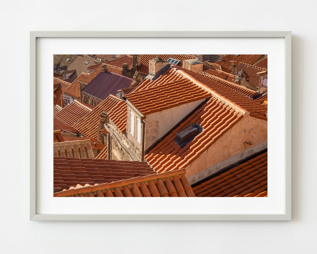 ic:Detailed close-up of traditional Croatian roof tiles, highlighting their unique texture and terra cotta color.