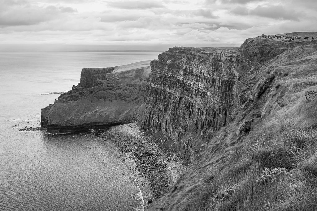 ic:Mystical Mists: A serene, rain-soaked view of the Cliffs of Moher, where each droplet adds to the ethereal ambiance of this Irish natural wonder.