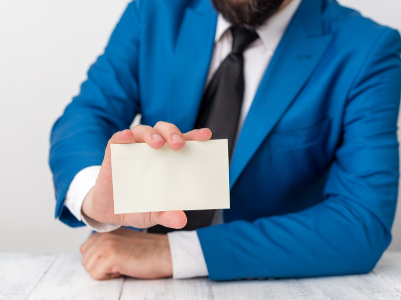 People holding large blank white cards