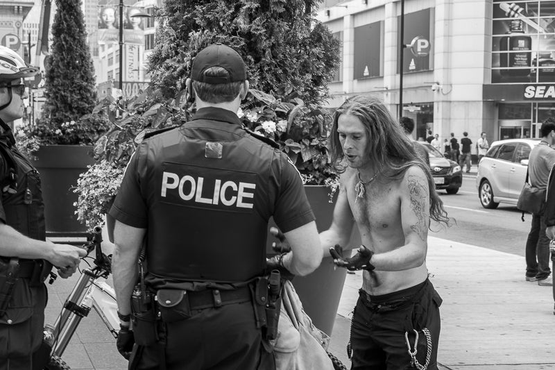 Police talking to protestor 2010 G7 Summit Toronto Canada