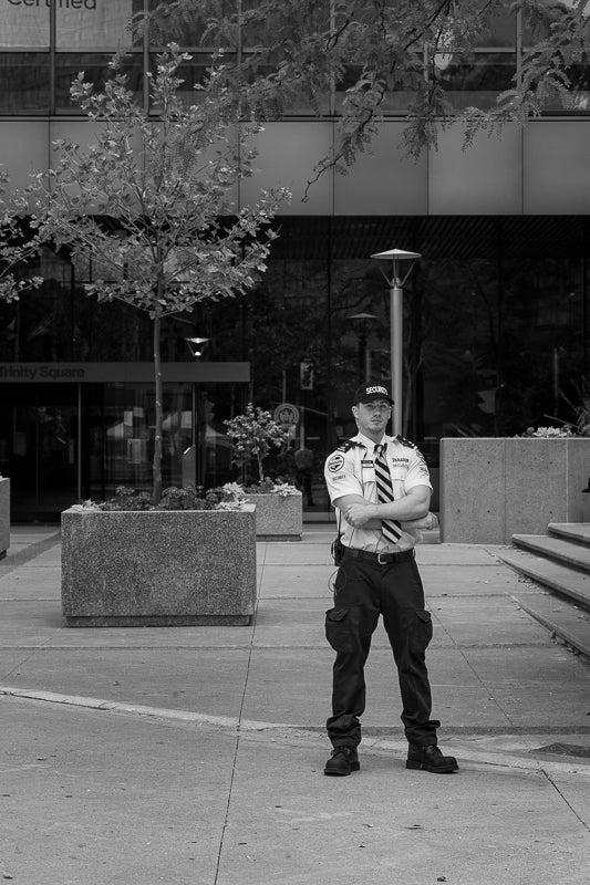 Security guard standing outside an office building in Toronto