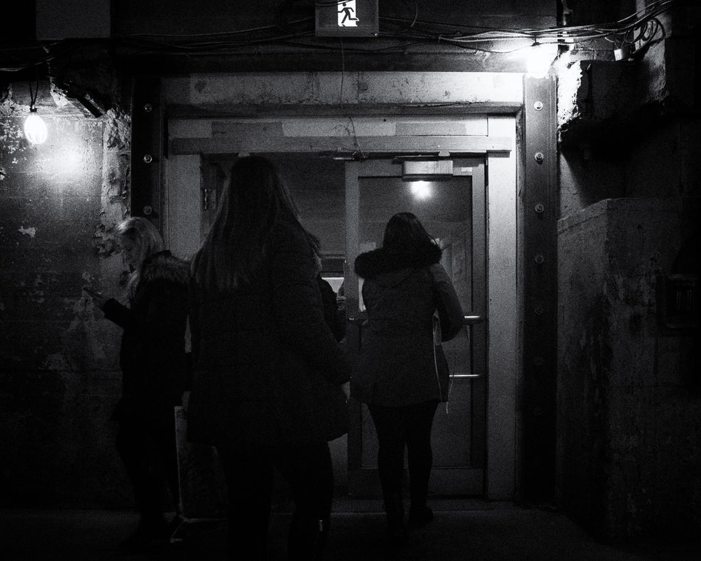ic:Cold and dark exit at Toronto Union as a woman reads her mobile phone