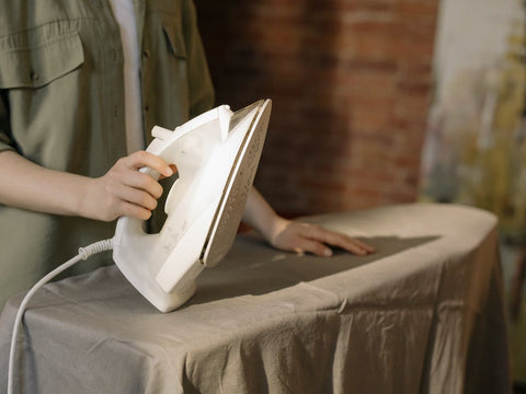 Men ironing a sheet