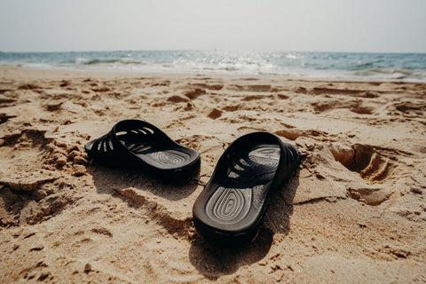 Black sandals on beach