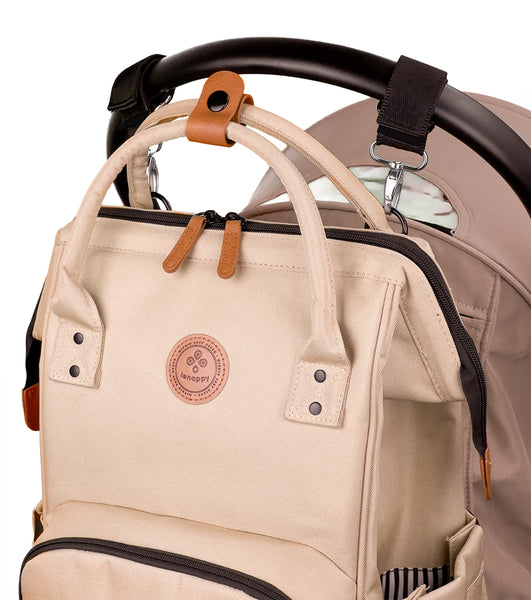 Lenappy diaper bag in champagne color hanging on a Yoyo stroller using the provided stroller hooks