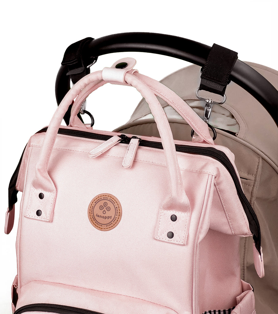 Lenappy diaper bag in Nude Pink color hanging on a Yoyo stroller using the provided stroller hooks