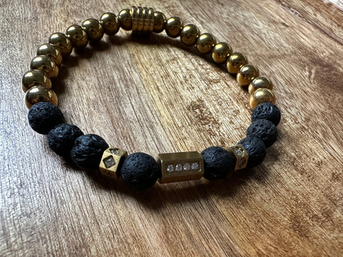 Black and gold men's bracelet made with stainless steel and lava rock.