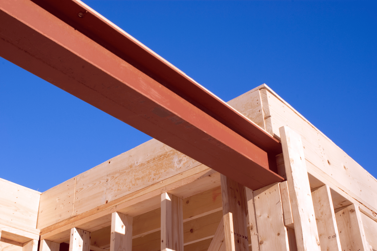 a steel beam installed horizontally across a wooden home frame