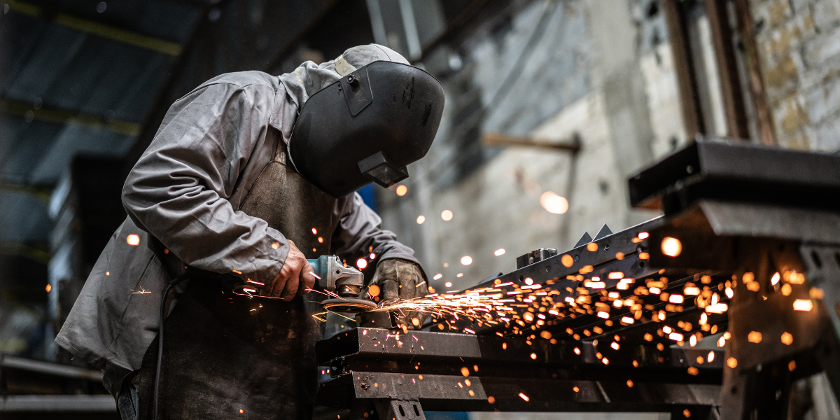 man welding steel with sparks flying