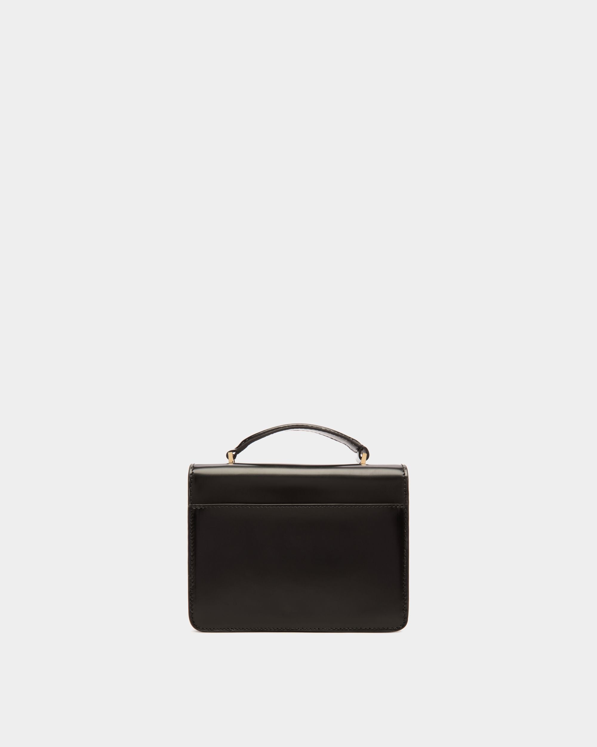 Ollam | Women's Mini Top Handle Bag in Black Brushed Leather | Bally | Still Life Back