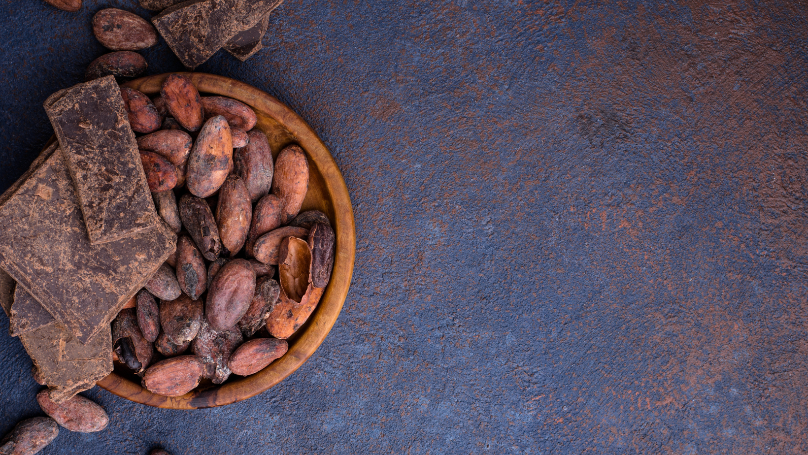 Artisanal Mexican cacao beans with pieces of Mexican artisanal chocolate in a bowl in preparation for grinding to make drinking chocolate