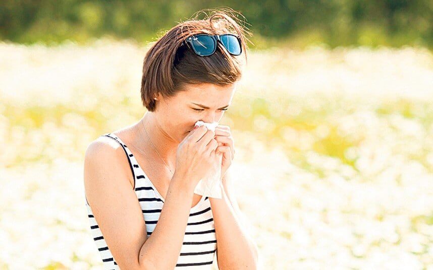 Lady blowing her nose because of Hayfever