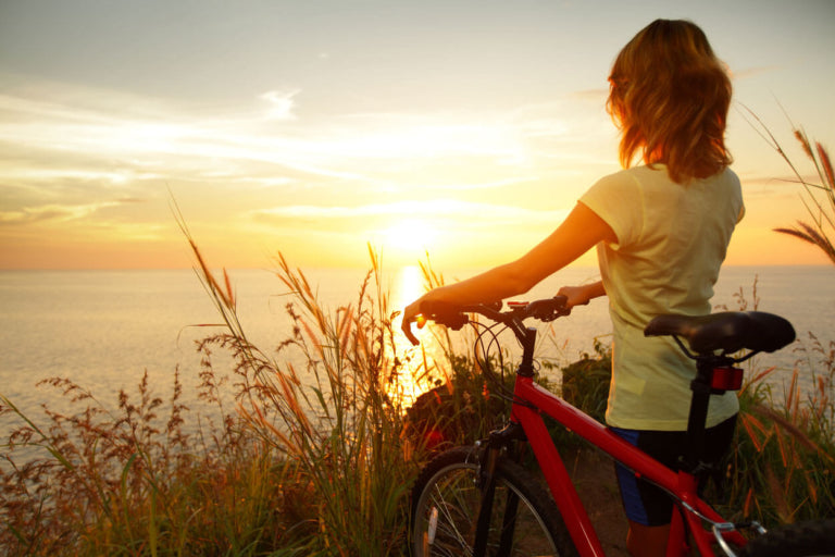 Women looking out over the sunset horizon