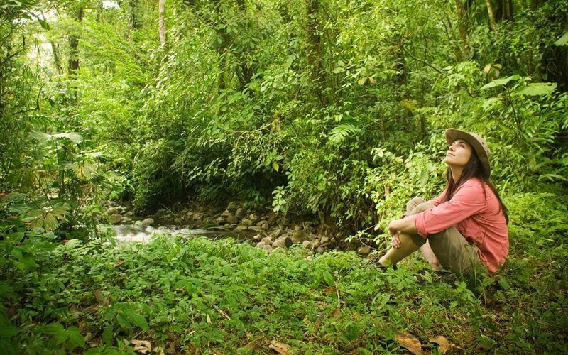 Women sat by stream in Nature