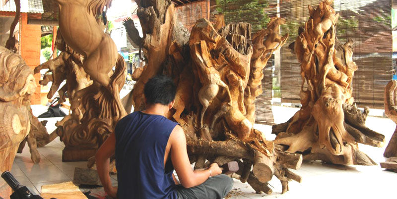 a Man is Carving wooden Sculpture