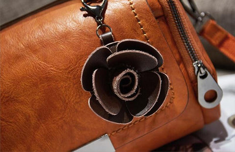 rose accessory on a boston pillow bag