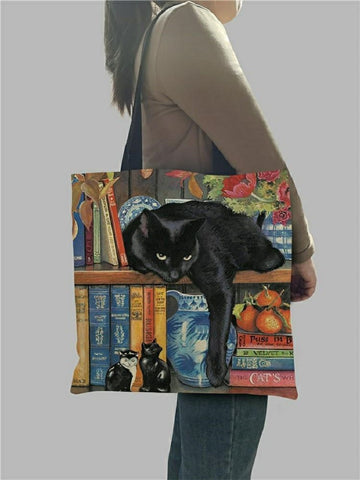woman carrying a cat tote bag on her shoulder