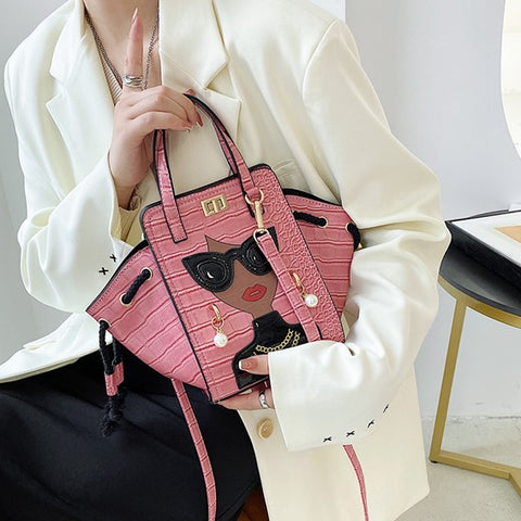woman hand carries pink unique purses, novelty purses, unique handbag, novelty bags, quirky handbag