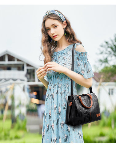 woman slinging a black tote bag over her shoulder