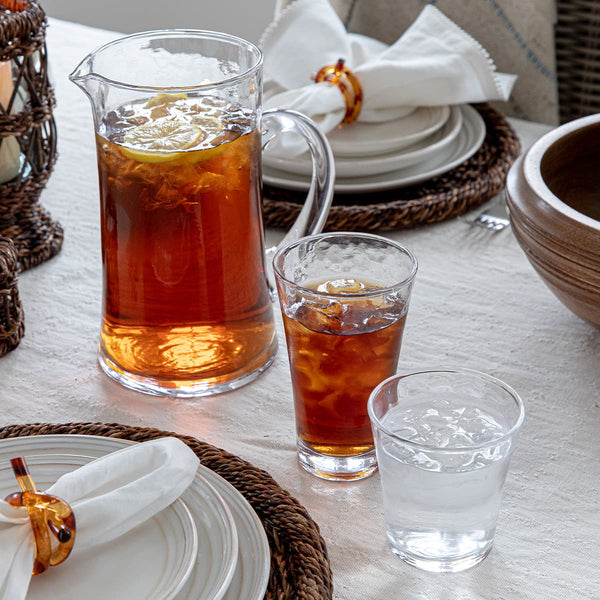 orange juice and water in pitcher on plate, Stock image