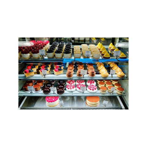 Pastry case filled with assorted types of lovely sweets in many colors