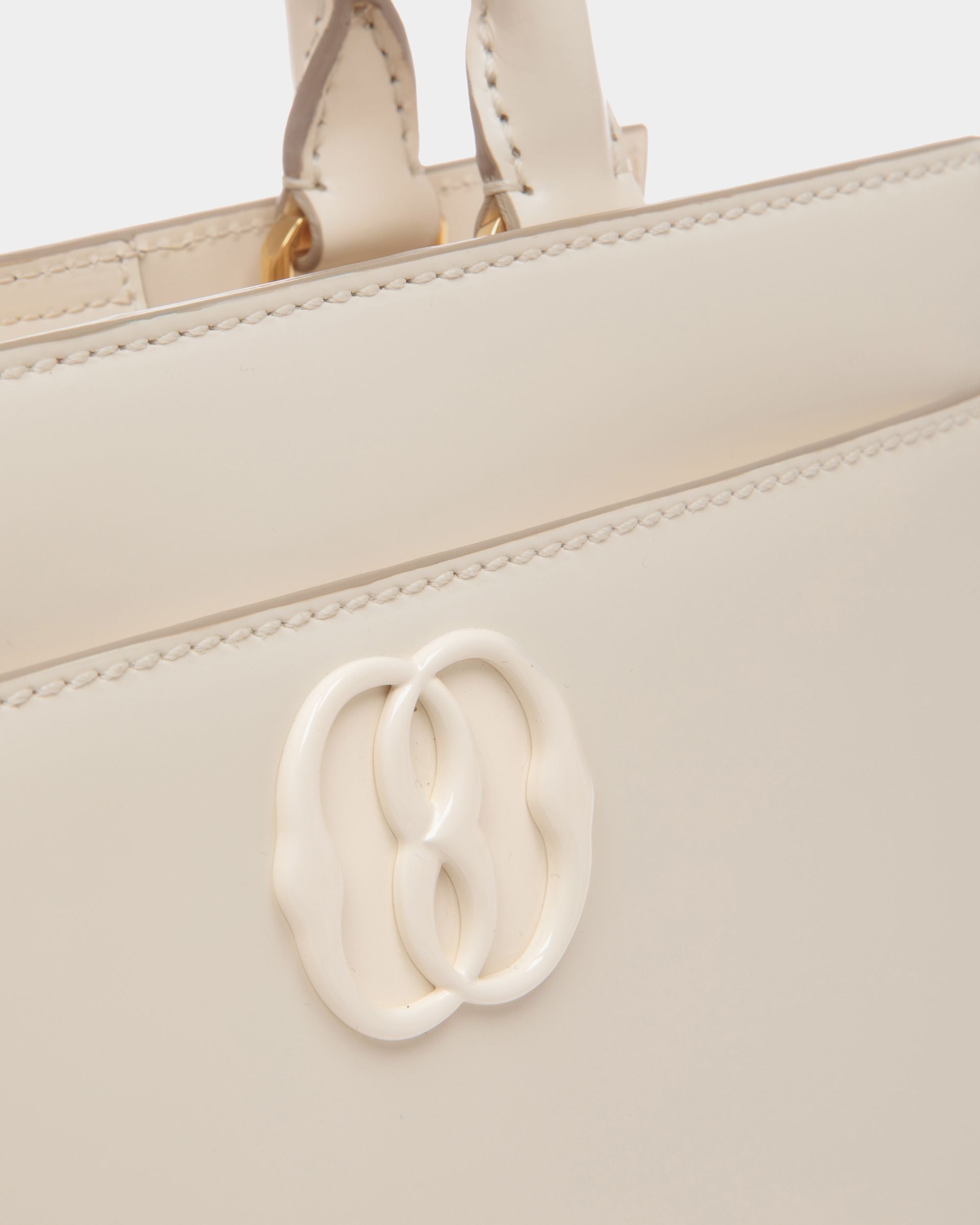 Emblem | Women's Small Tote Bag in White Brushed Leather | Bally | Still Life Detail