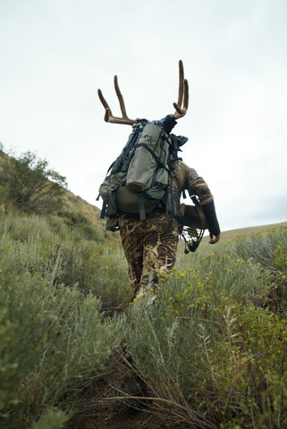 Stone Glacier pack with hunter packing out mule deer