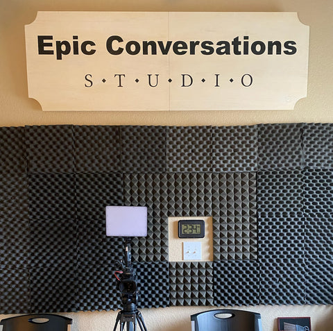 Epic Conversations Studio Sign in black letters on whitewashed board hanging on studio wall