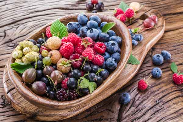 the-modern-gentleman-ripe-berries-in-the-wooden-bowl