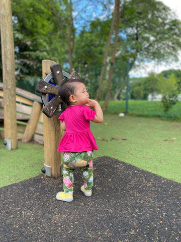 young toddler in leggings at playground