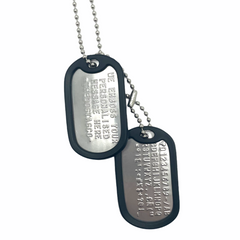 a photograph of a single dog tag with a keychain ball bead chain.