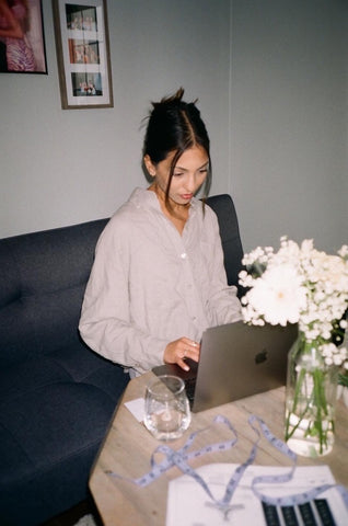 young woman working on laptop with polaroid edited film