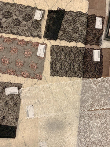 lace fabrics laying out on the floor