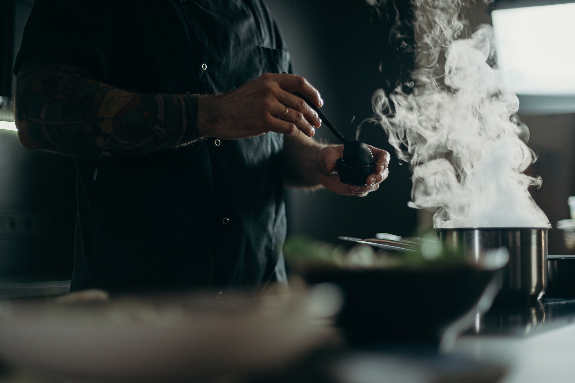 chef cooking meal over smoking pot