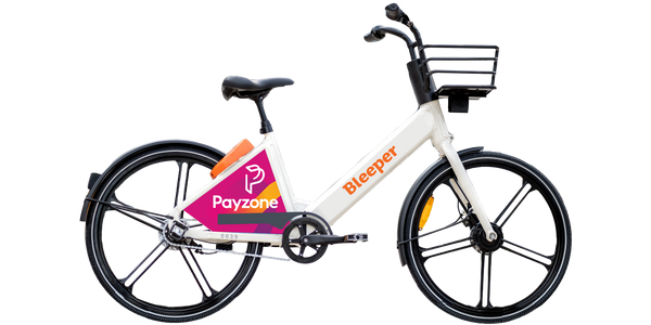 A photo of a Bleeper shared electric bike with the branding of sponsor Payzone on the rear wheel.