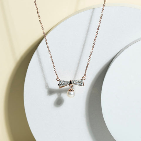 Ballerina: Silver rose gold plated ⌀4.5 mm freshwater pearl with CZ ribbon bow drop pendant, 16" cable chain necklace