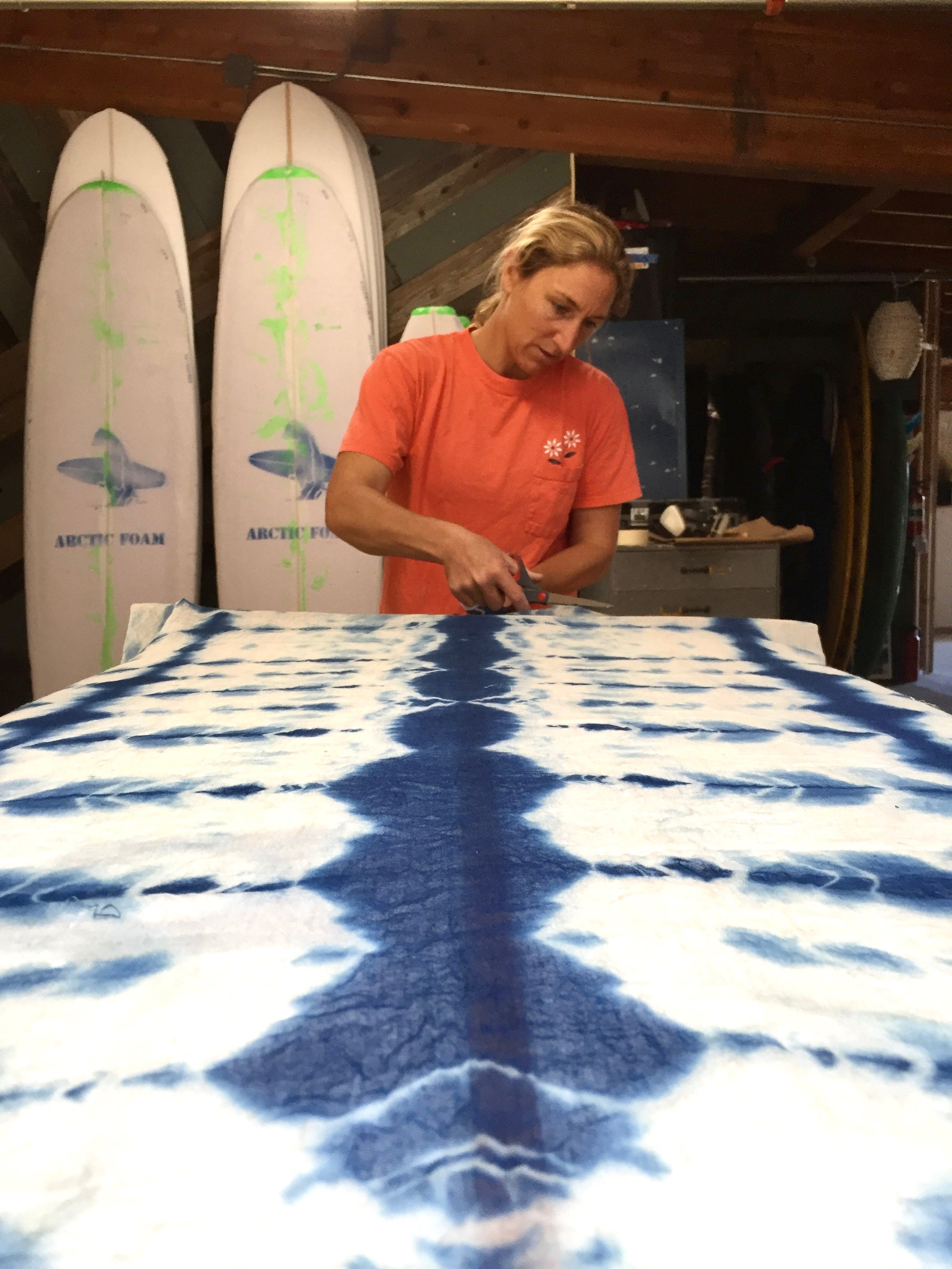 Ashley cutting Margaret's hand dyed indigo fabric for her surfboard
