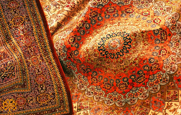 Luxurious silk composition and delicate patterns of a Qom rug, known for its intricate detail.