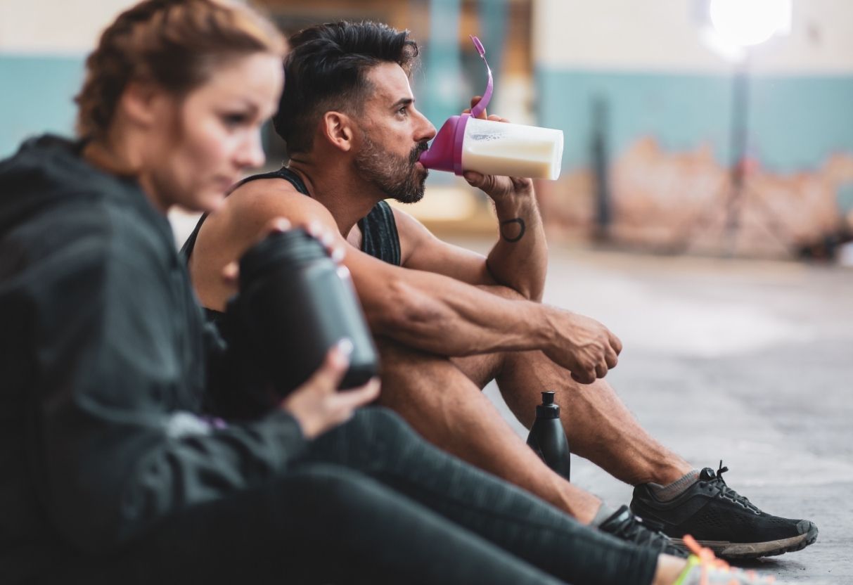 Two people drinking a protein shake