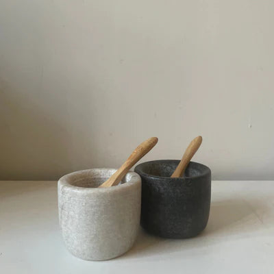 marble and granite salt and pepper pots with wooden spoons