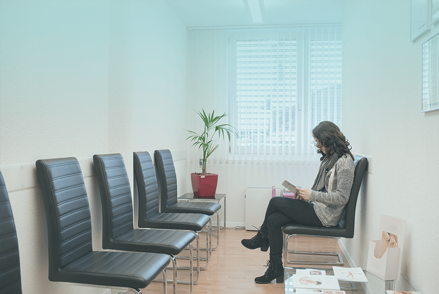 Woman waiting in doctor's office waiting room