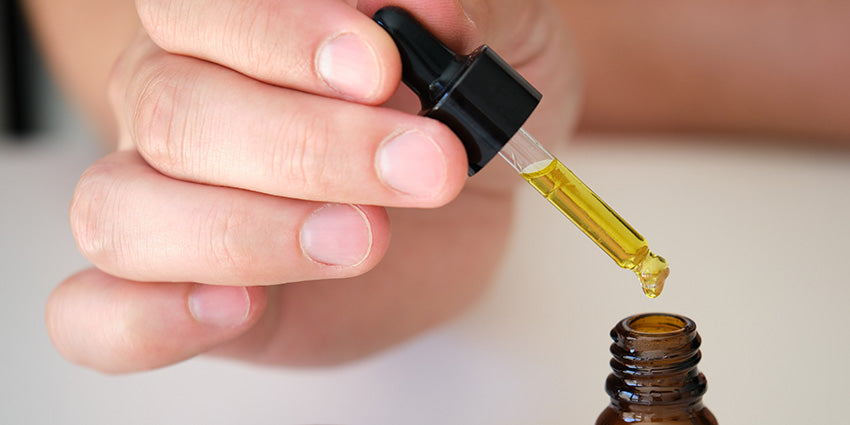 Man dosing CBD oil for stress and calm. Buy CBD oil for depression and anxiety from Oscity Labs.