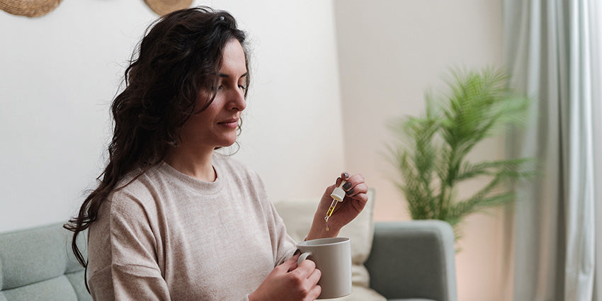 Woman using CBN oil tincture as a sleep aid. Buy CBN & CBD gummies online.