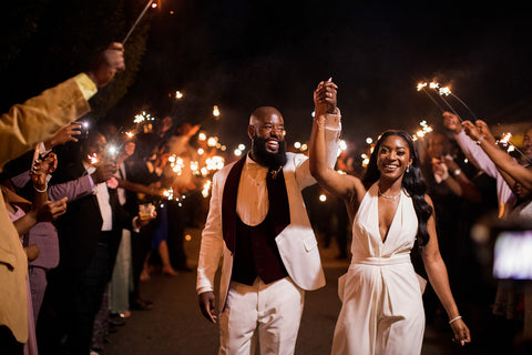 Couple leaving their reception with guests holding wedding sparklers