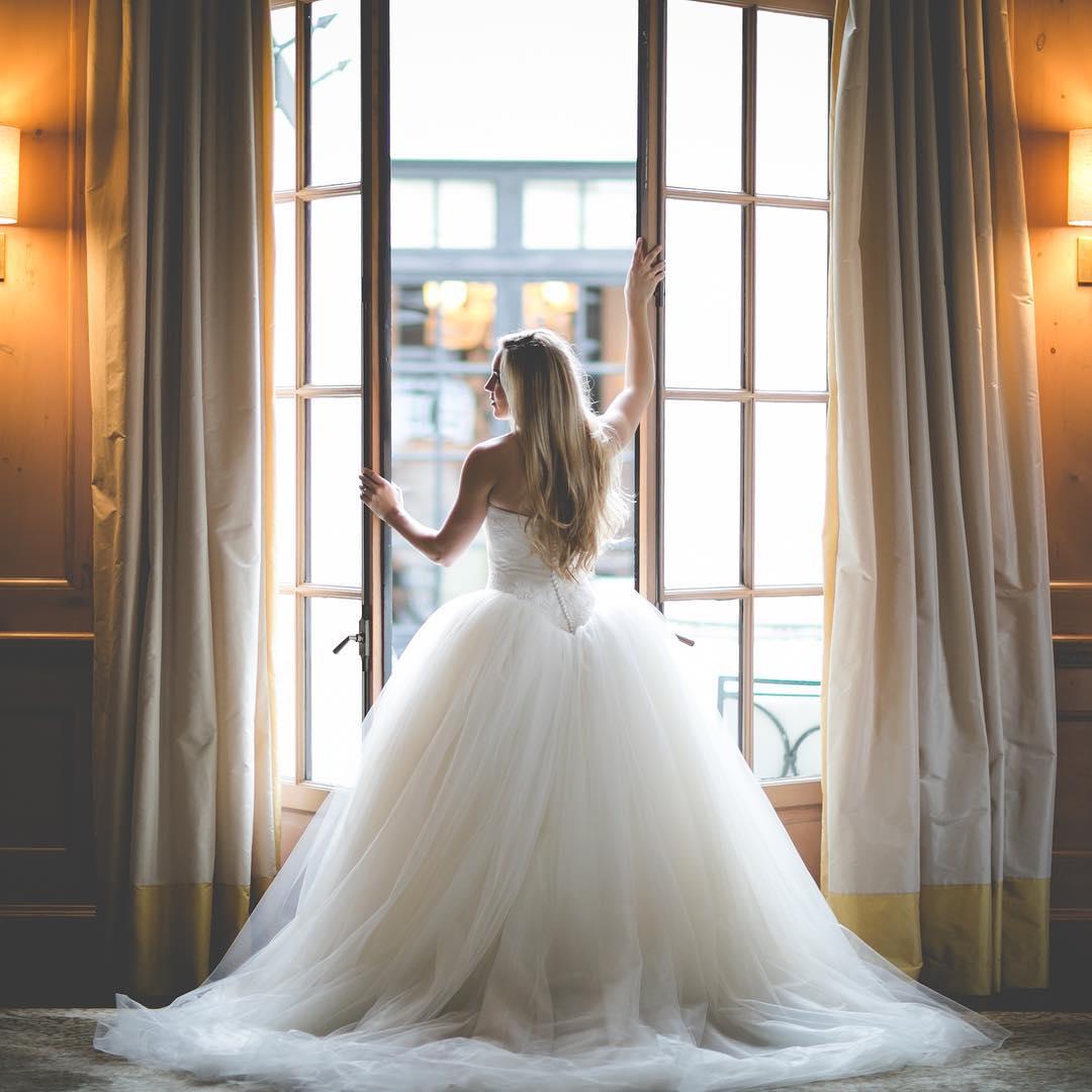 bride standing at open french doors staring over her shoulder