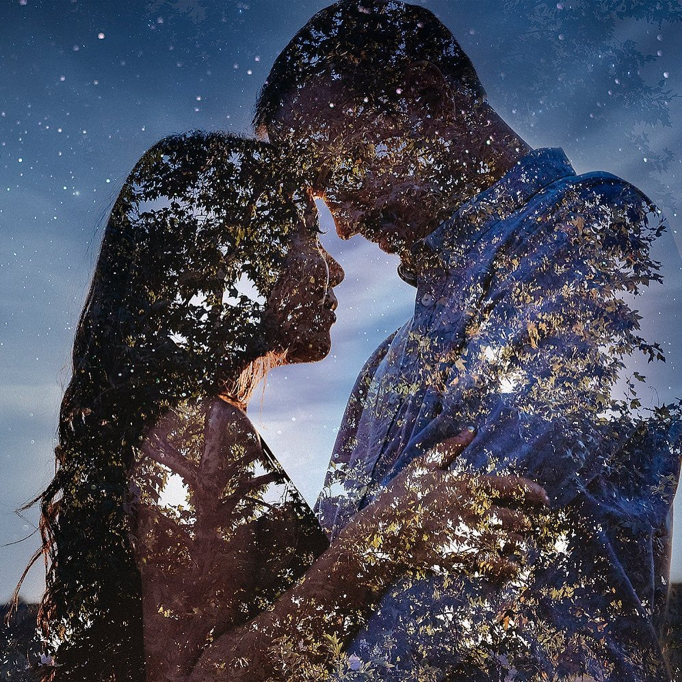 a double exposure image of a couple and a tree during the twilight