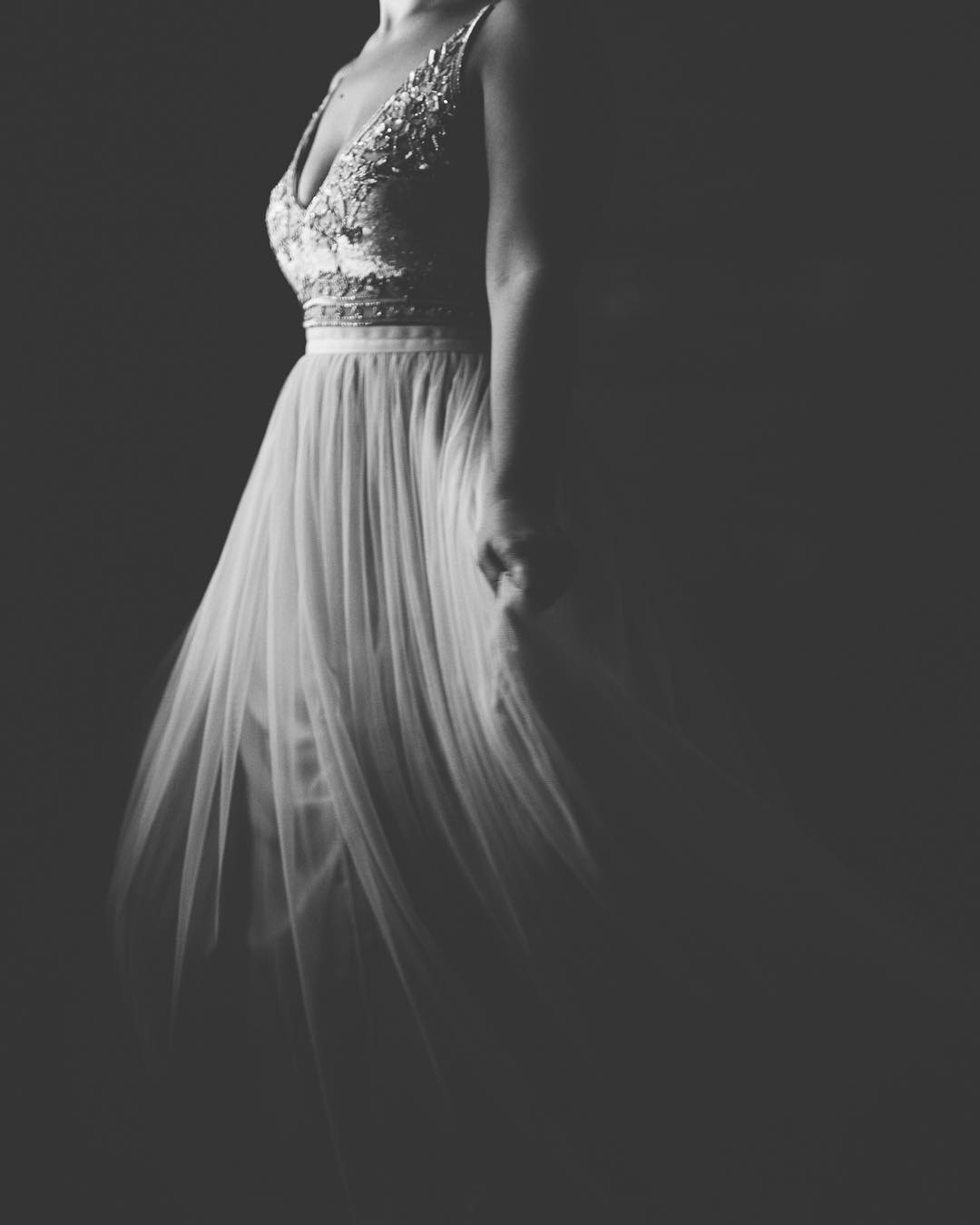 A monochrome image a bride wearing a wedding dress