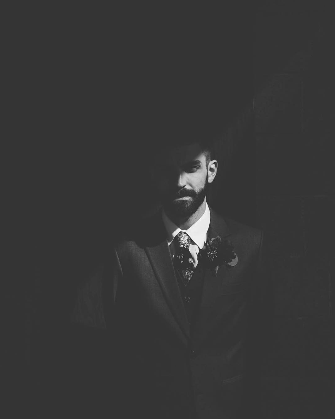 A creatively shot image of bridegroom with lights and shadows